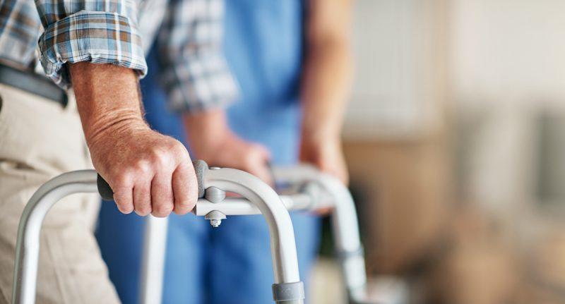 Person holding onto a walker