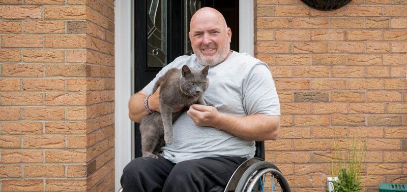 Man in wheelchair with cat