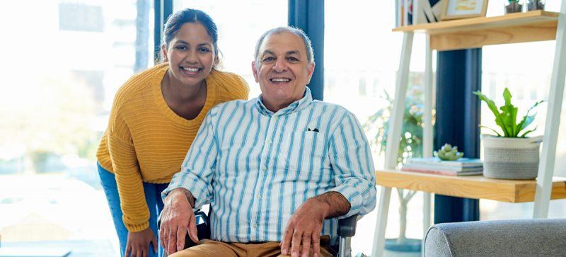 Man in wheelchair with woman standing next to him