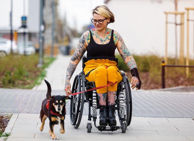 Woman in wheelchair with dog