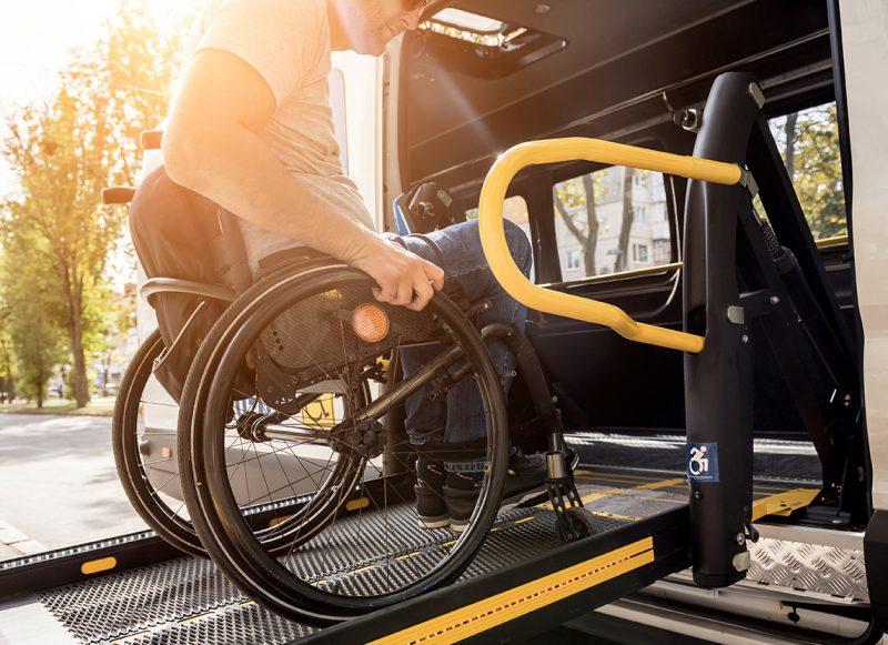 Man in wheelchair getting on lift